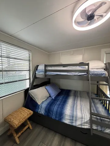 a living room with a bed and dresser