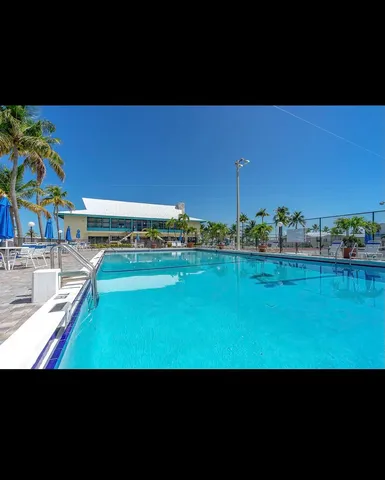 a view of a swimming pool with a yard