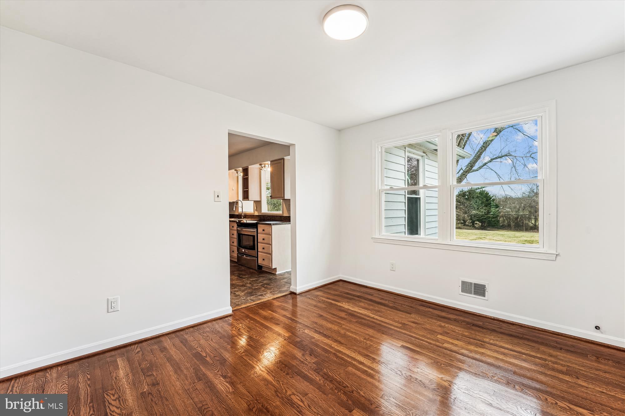 8475 Wedding Drive Welcome, MD 20693 - Photo 18 of 48 a view of empty room with wooden floor and fan