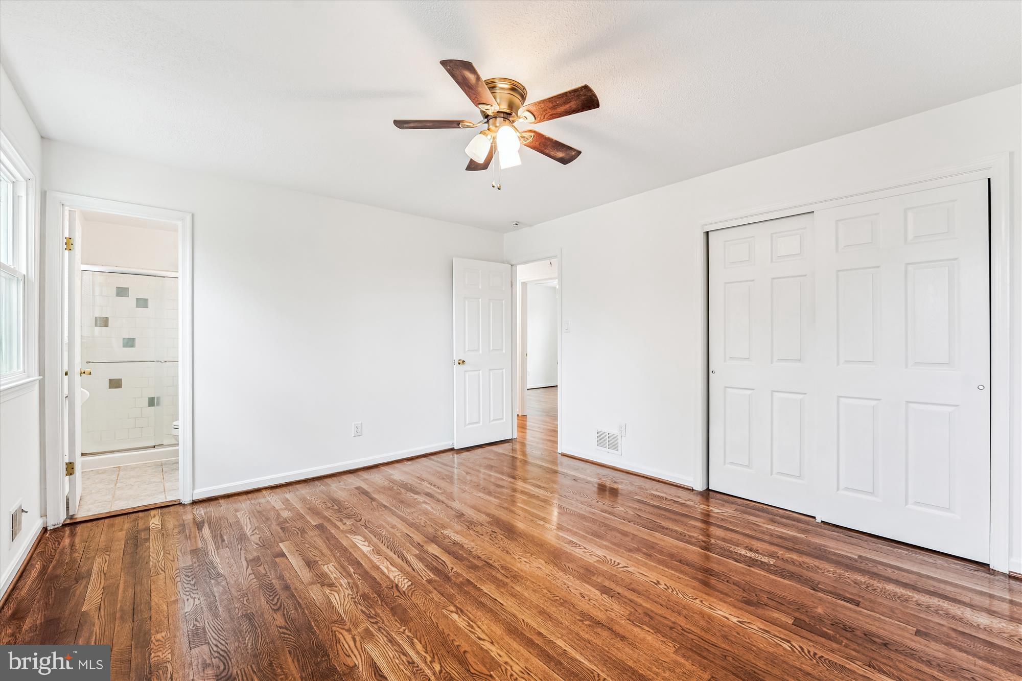 8475 Wedding Drive Welcome, MD 20693 - Photo 22 of 48 an empty room with wooden floor a ceiling fan and windows