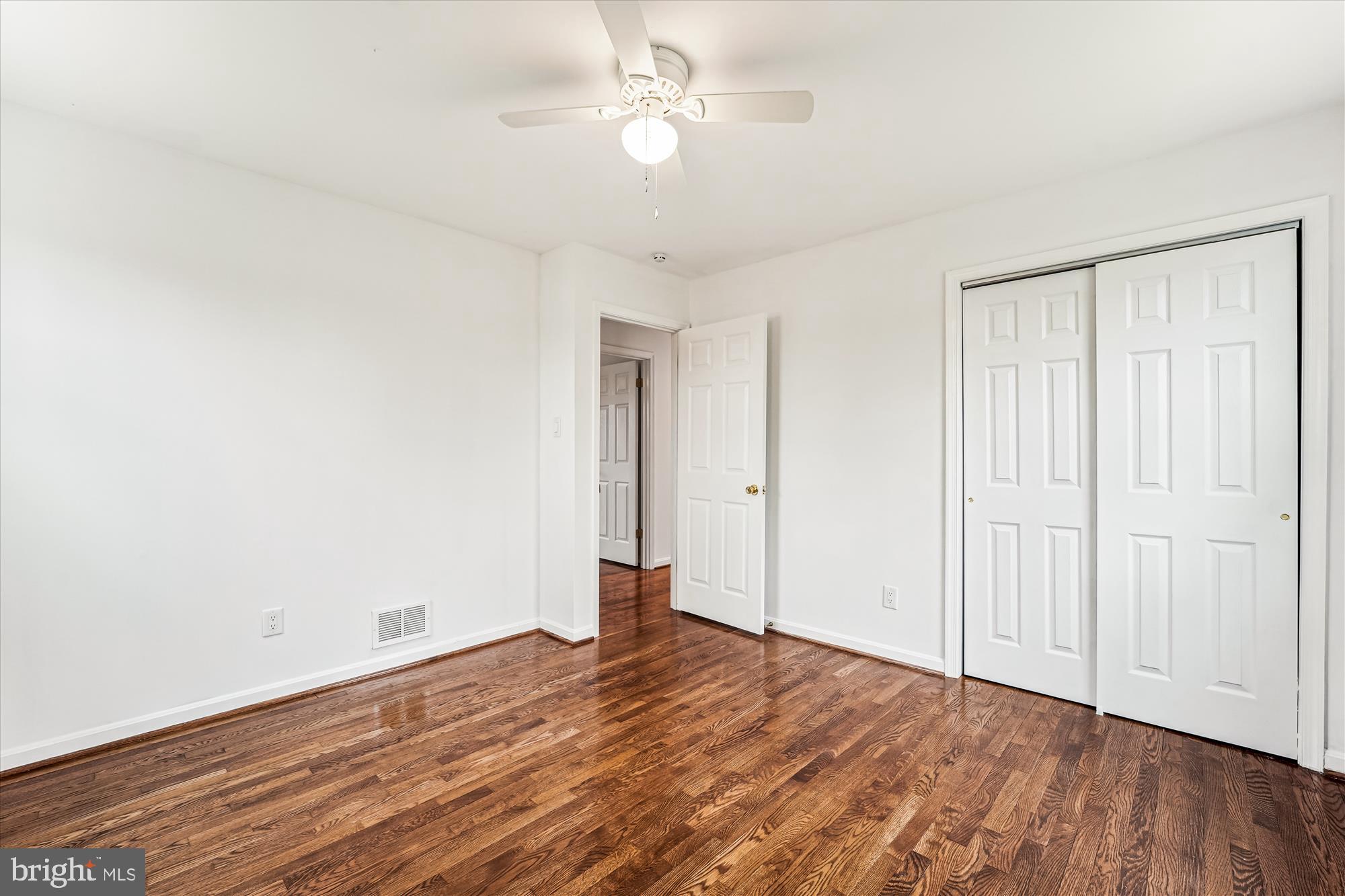 8475 Wedding Drive Welcome, MD 20693 - Photo 30 of 48 an empty room with wooden floor and ceiling fan