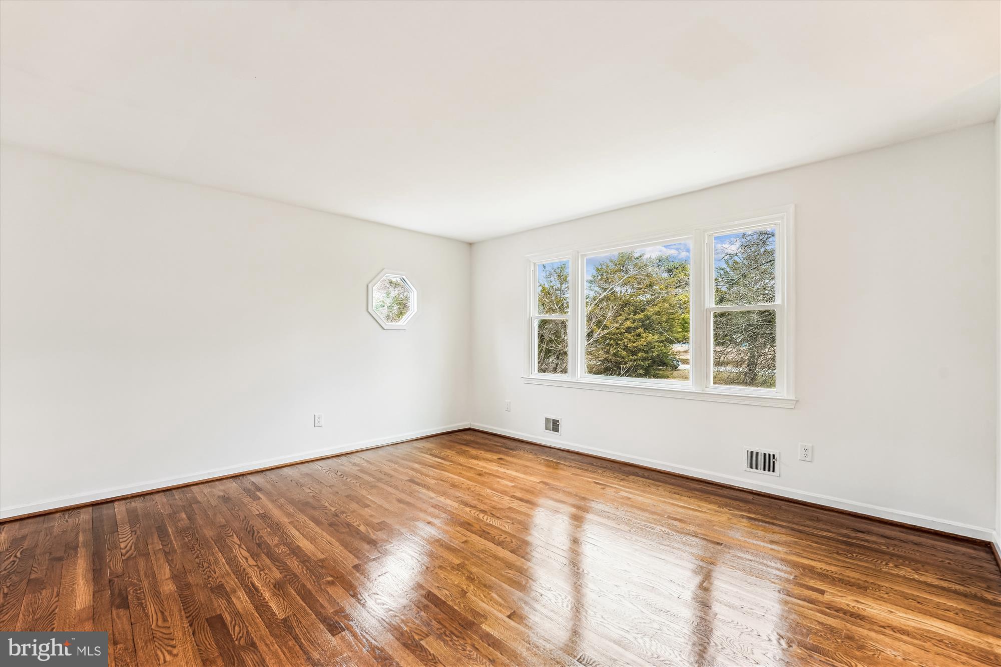 8475 Wedding Drive Welcome, MD 20693 - Photo 4 of 48 an empty room with wooden floor and windows