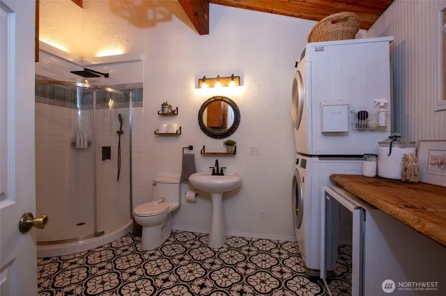 a bathroom with a granite countertop toilet sink and mirror