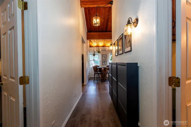 a view of a hallway with wooden floor and stairs