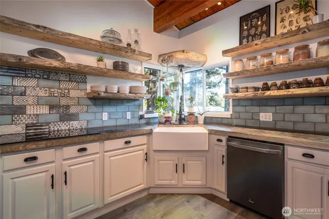 a kitchen with stainless steel appliances granite countertop a sink and cabinets