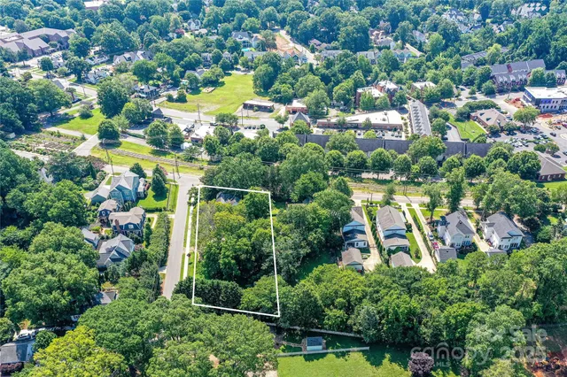 an aerial view of residential houses with outdoor space and swimming pool