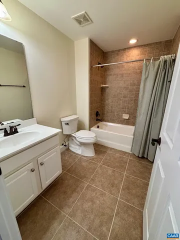 a bathroom with a bathtub shower sink and toilet