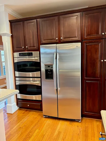 a kitchen with wooden cabinets and a stainless steel appliances