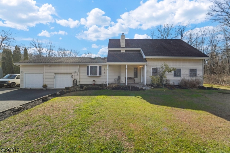 a view of a house with swimming pool and a yard