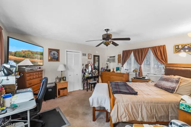 a bedroom with furniture and a large window