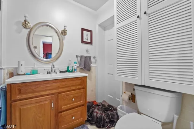 a bathroom with a toilet a sink and a mirror