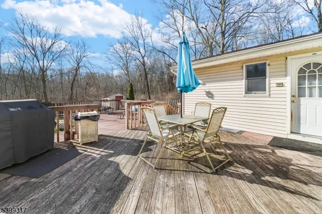 a view of a patio with table and chairs and wooden floor