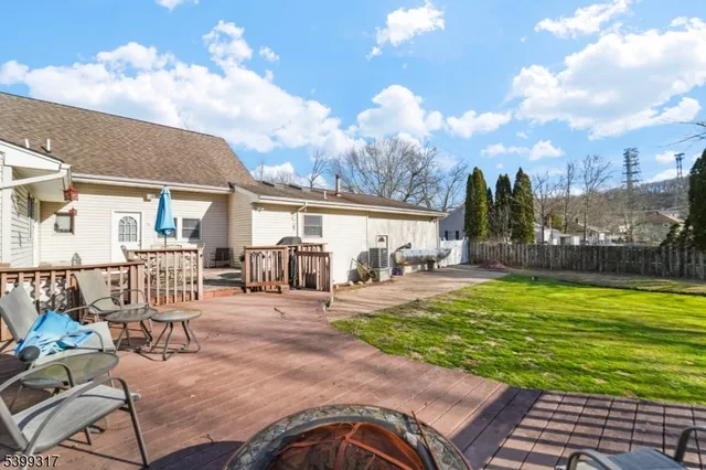 a view of a house with backyard porch and sitting area