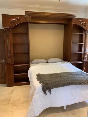 a bedroom with a bed and a cabinet