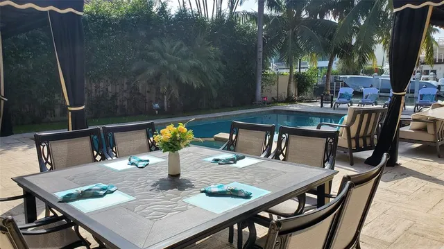 a view of a dining table and chairs in the patio