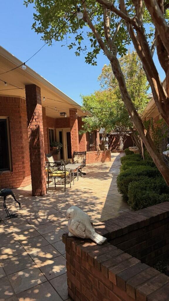 4226 97th Place Lubbock, TX 79423 - Photo 47 of 52 a view of a patio with a table chairs and a fire pit