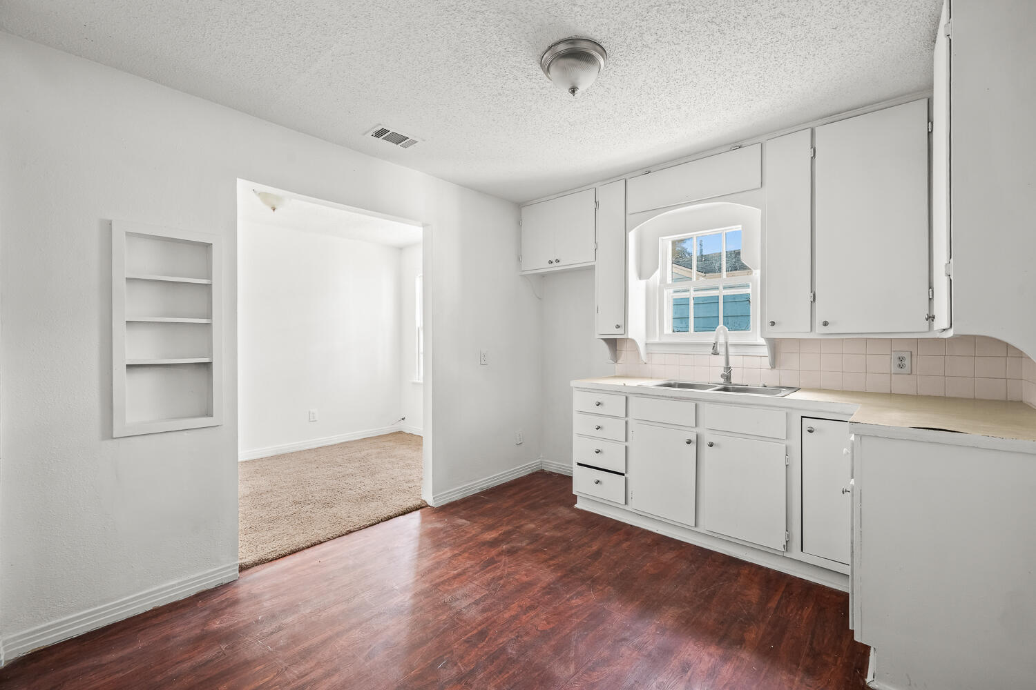 111 Avenue U Lubbock, TX 79415 - Photo 4 of 17 a room with a sink cabinets and a window