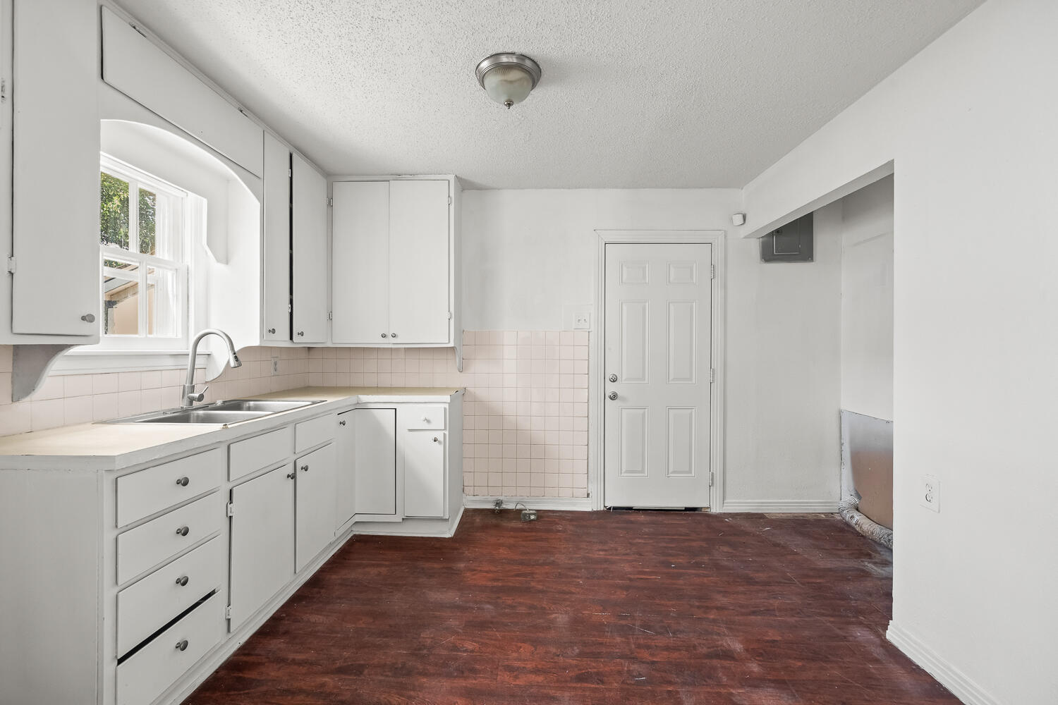 111 Avenue U Lubbock, TX 79415 - Photo 5 of 17 a kitchen with a sink cabinets and window