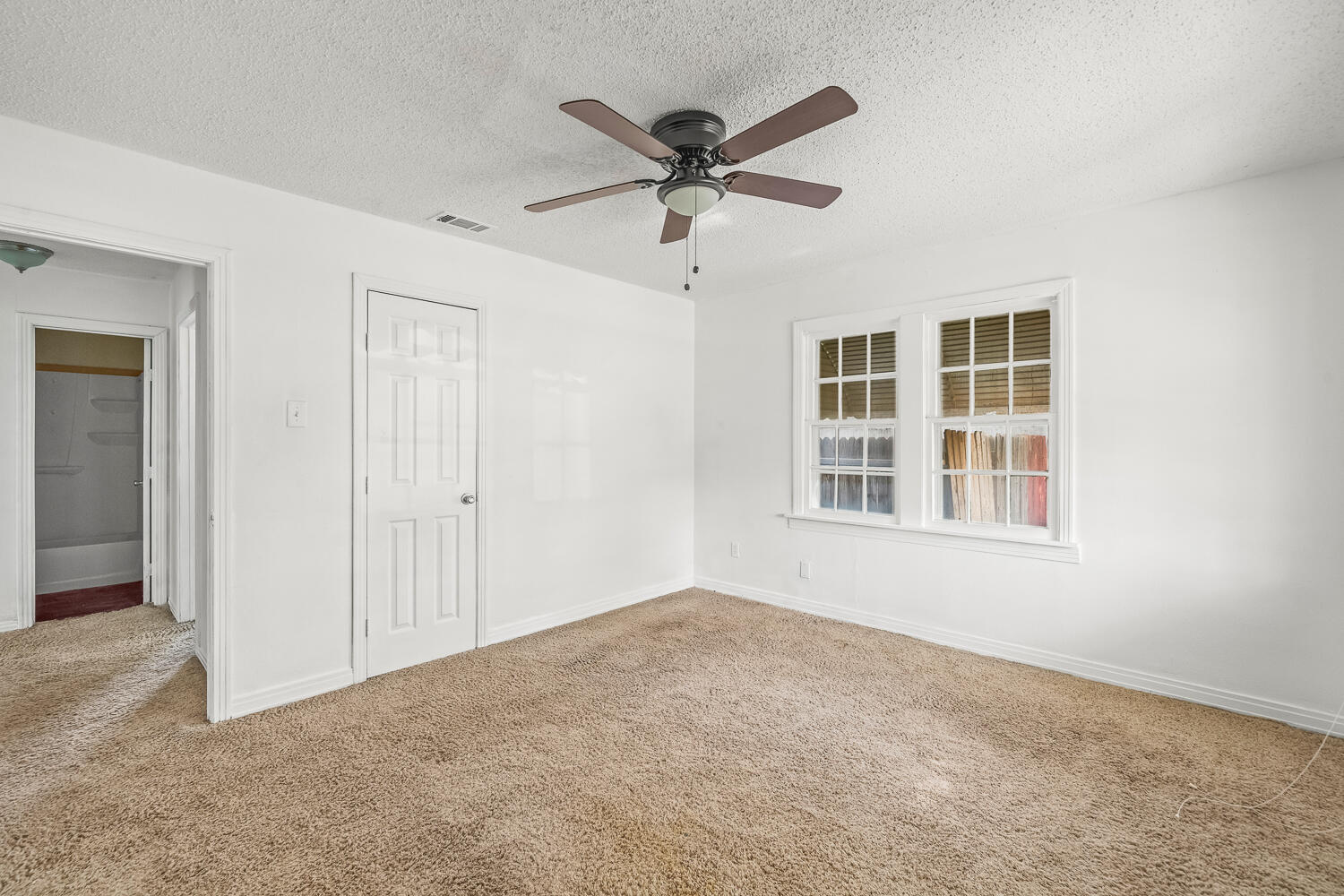 111 Avenue U Lubbock, TX 79415 - Photo 9 of 17 a view of a livingroom with a ceiling fan & windows