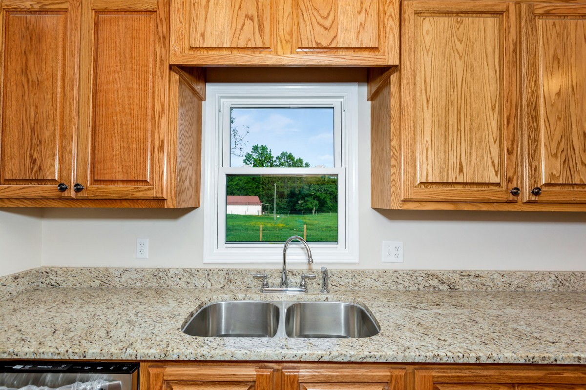 477 Holt Hollow Road Prospect, TN 38477 - Photo 11 of 34 a kitchen with granite countertop a sink and a window