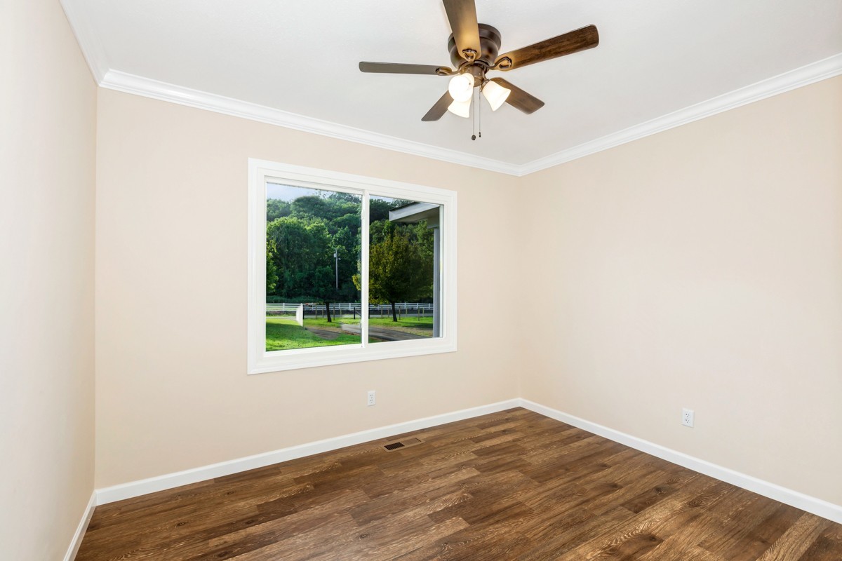 477 Holt Hollow Road Prospect, TN 38477 - Photo 13 of 34 an empty room with a window and a fan