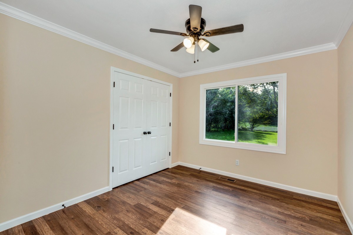 477 Holt Hollow Road Prospect, TN 38477 - Photo 14 of 34 a view of an empty room with wooden floor and a window