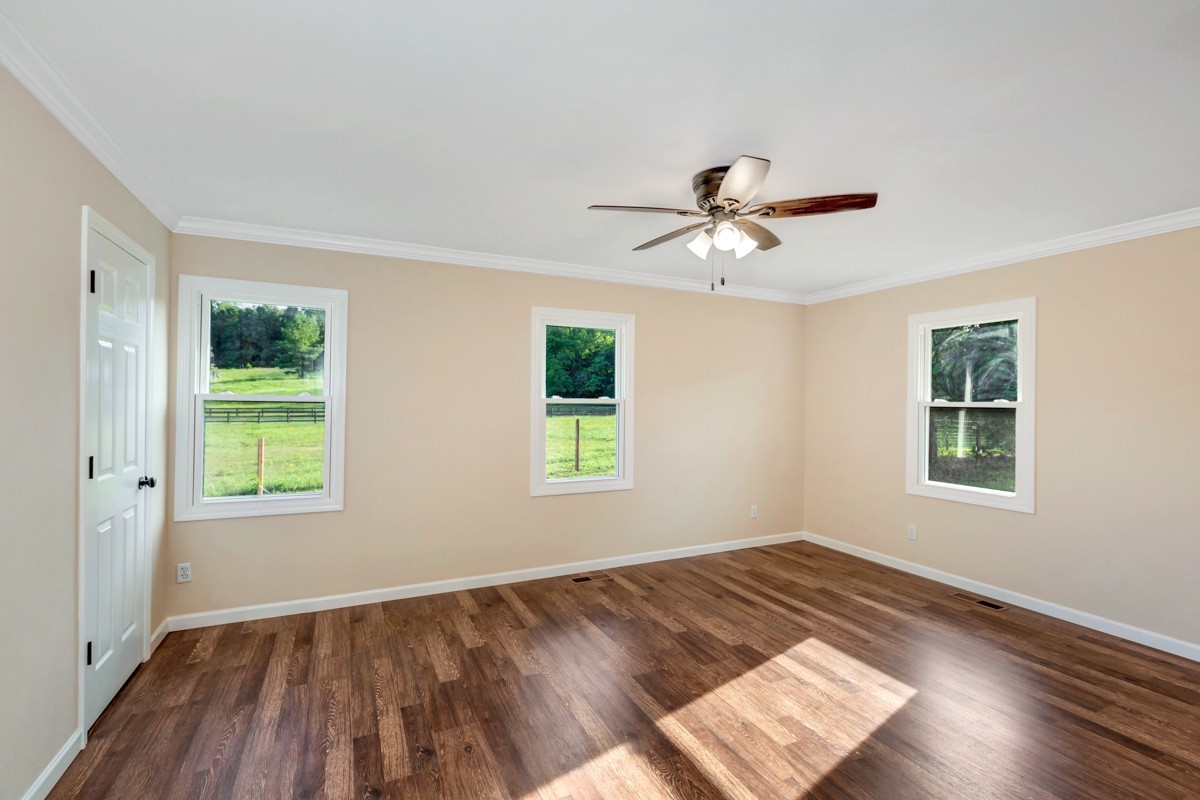 477 Holt Hollow Road Prospect, TN 38477 - Photo 17 of 34 a view of empty room with wooden floor and fan