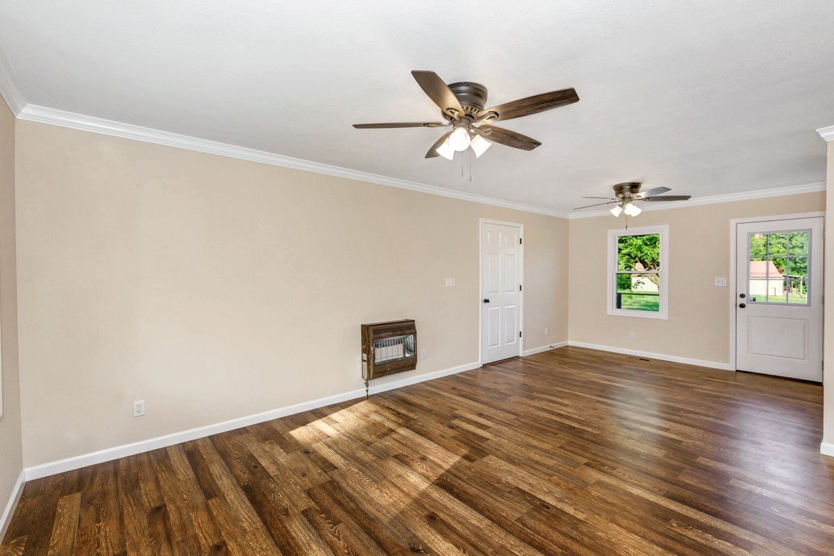 477 Holt Hollow Road Prospect, TN 38477 - Photo 4 of 34 a view of empty room with wooden floor and fan