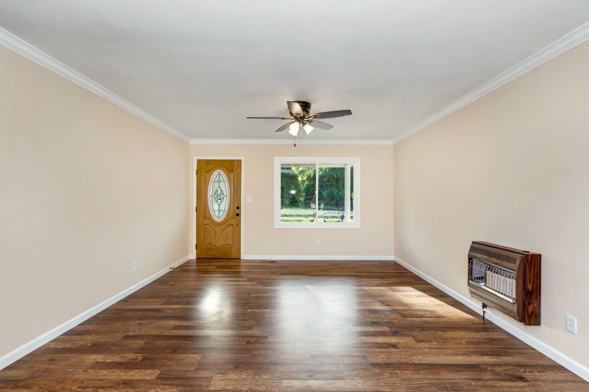 477 Holt Hollow Road Prospect, TN 38477 - Photo 7 of 34 a view of an empty room with a window and wooden floor