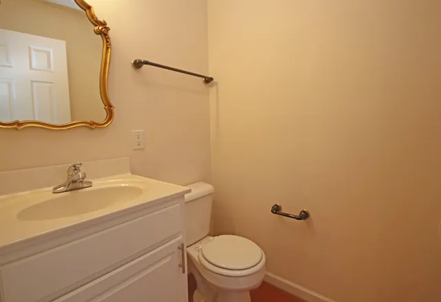 a bathroom with a sink a toilet and a mirror