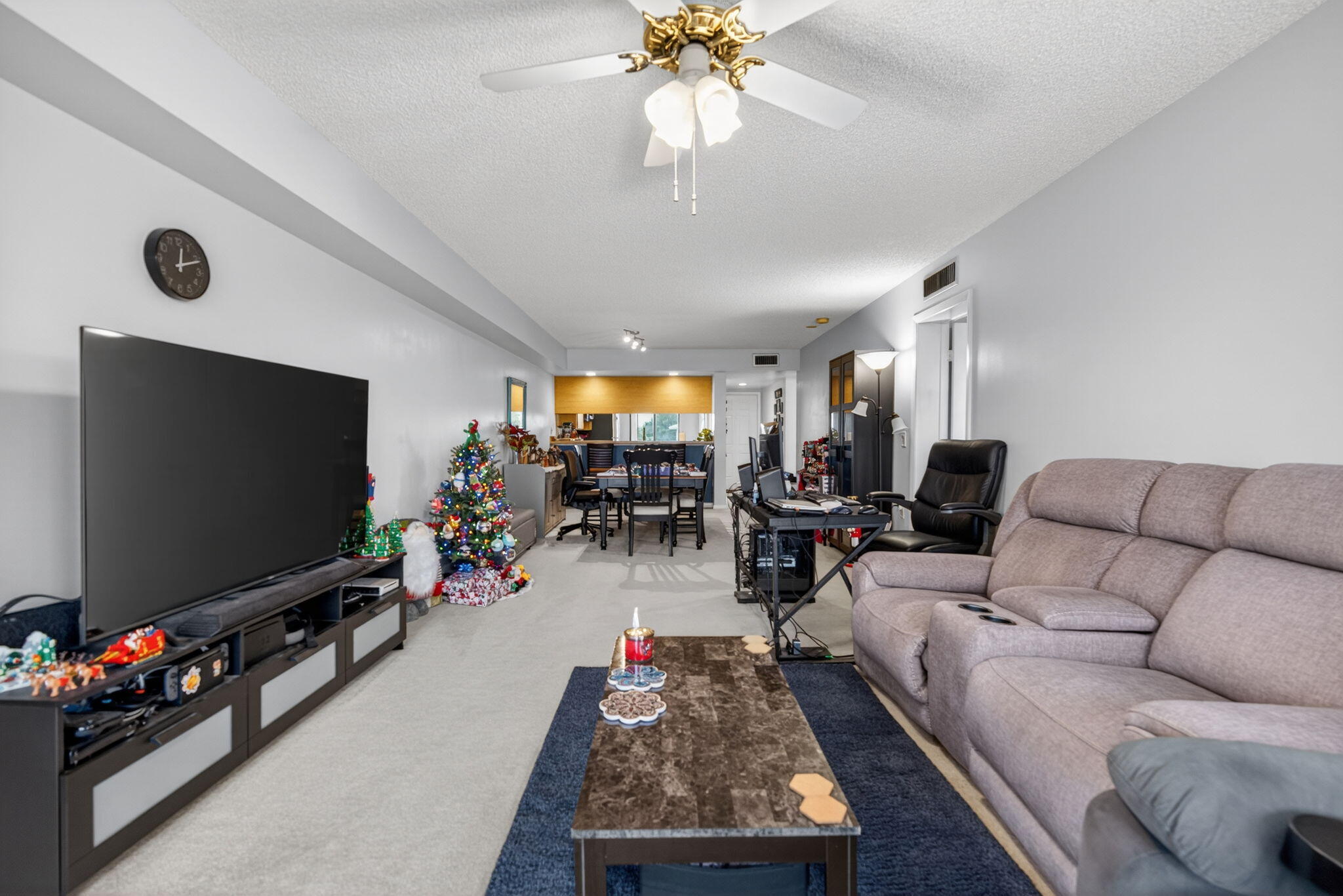 2441 Village Boulevard, Unit 405 West Palm Beach, FL 33409 - Photo 11 of 24 a living room with furniture and a flat screen tv