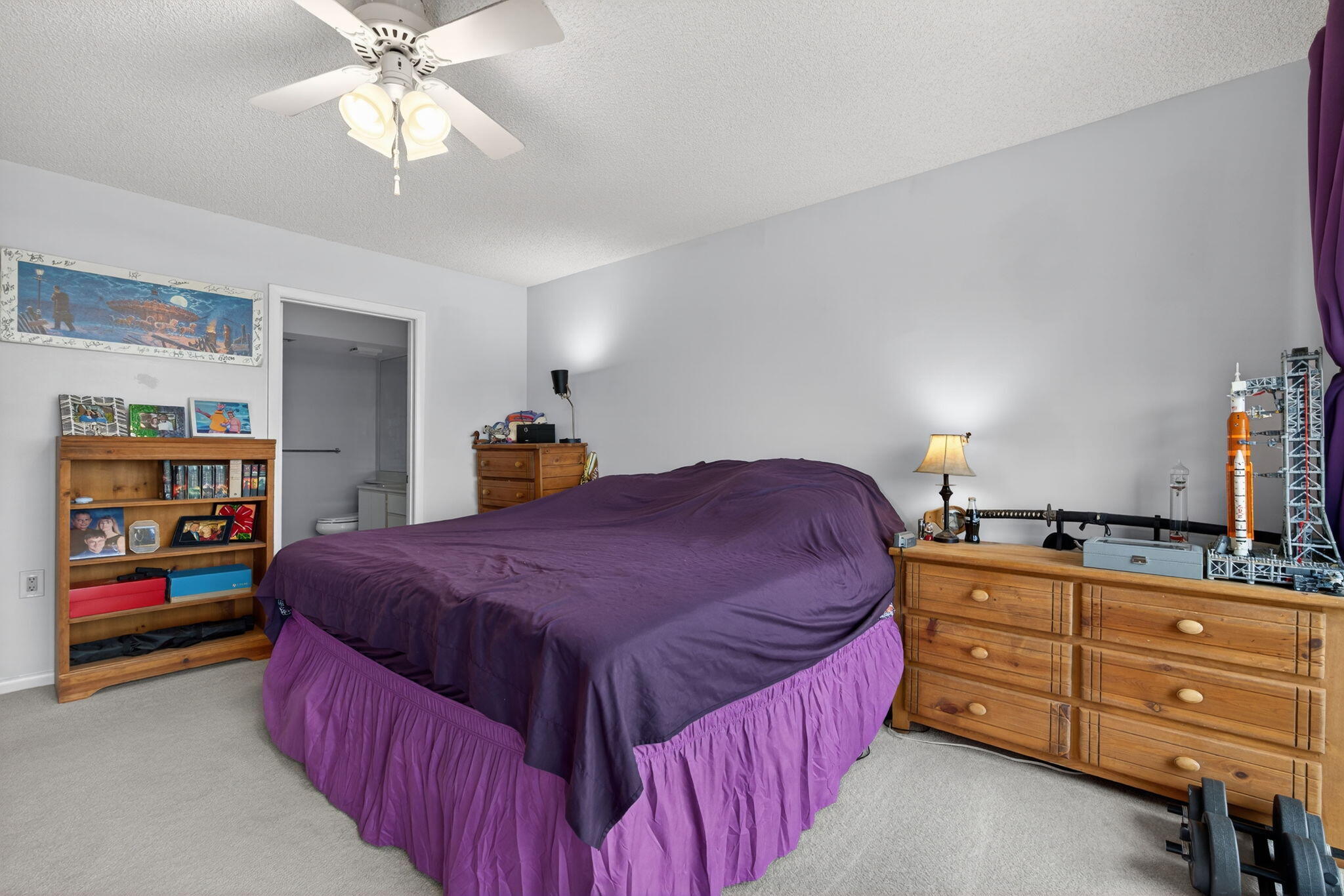 2441 Village Boulevard, Unit 405 West Palm Beach, FL 33409 - Photo 12 of 24 a bedroom with a bed and dresser