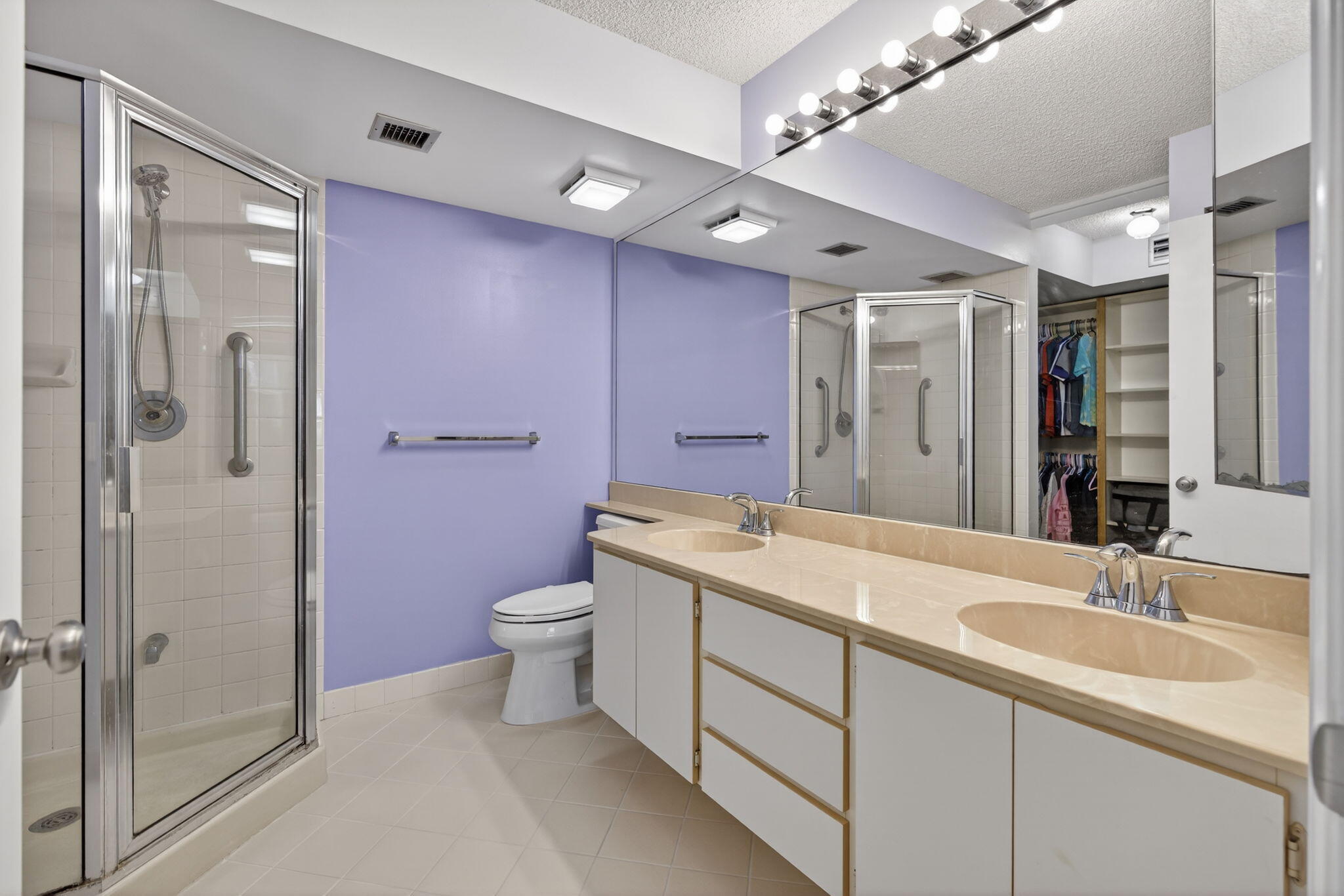 2441 Village Boulevard, Unit 405 West Palm Beach, FL 33409 - Photo 13 of 24 a bathroom with a sink a toilet and shower