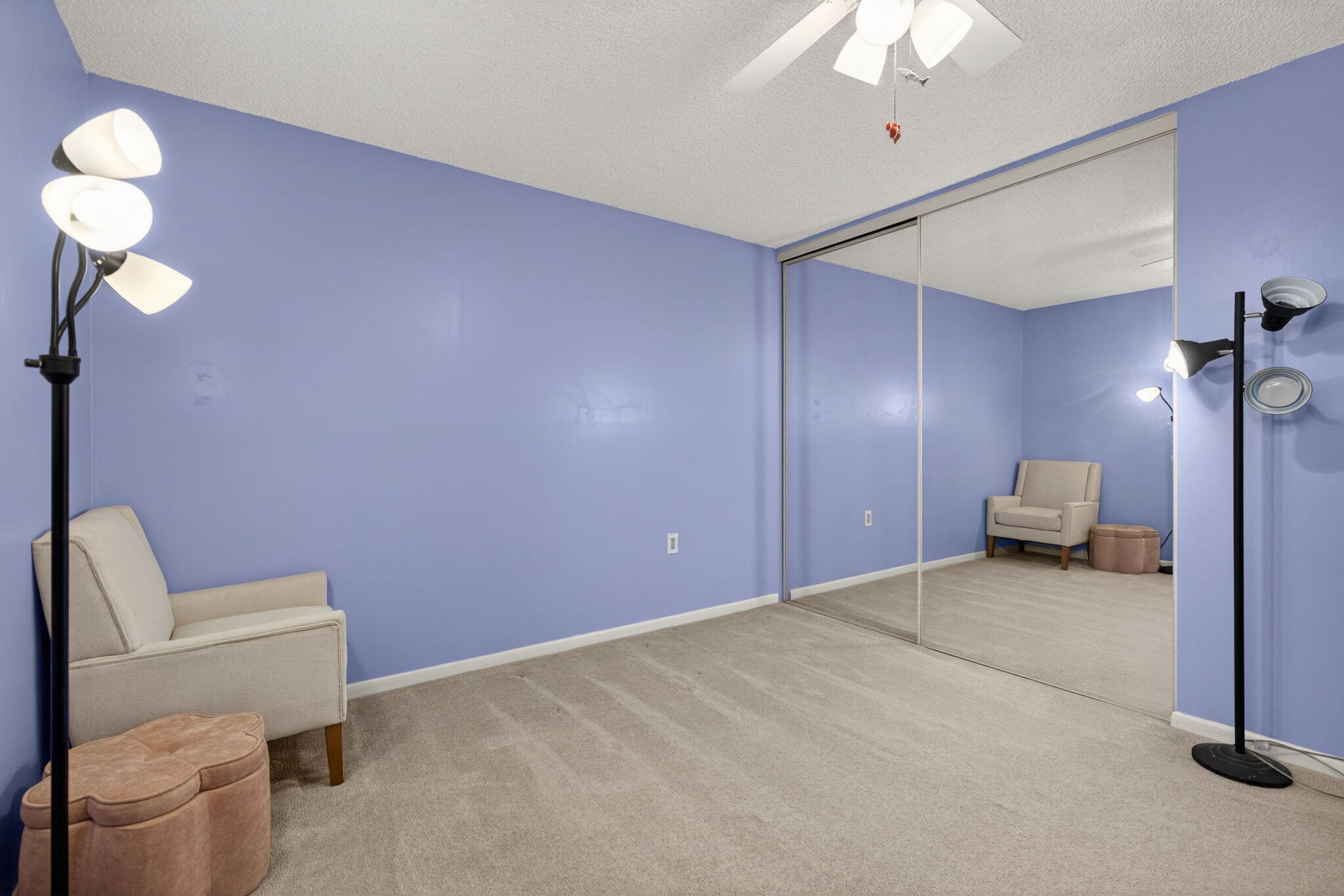 2441 Village Boulevard, Unit 405 West Palm Beach, FL 33409 - Photo 16 of 24 a bedroom with a bed and a chandelier