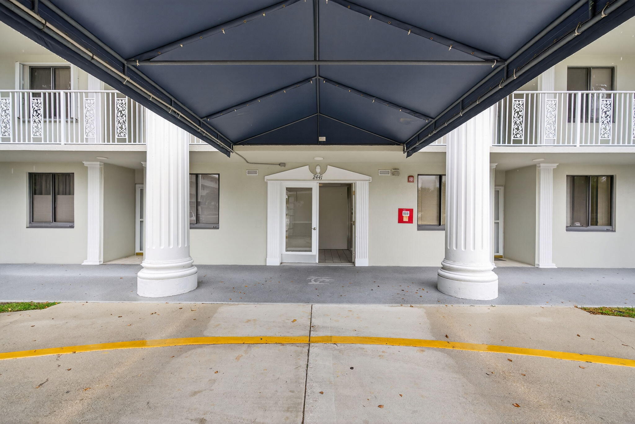 2441 Village Boulevard, Unit 405 West Palm Beach, FL 33409 - Photo 2 of 24 a swimming pool with yard