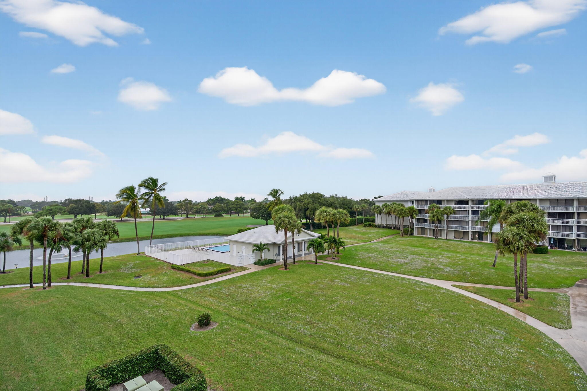 2441 Village Boulevard, Unit 405 West Palm Beach, FL 33409 - Photo 21 of 24 a view of a big room with a big yard