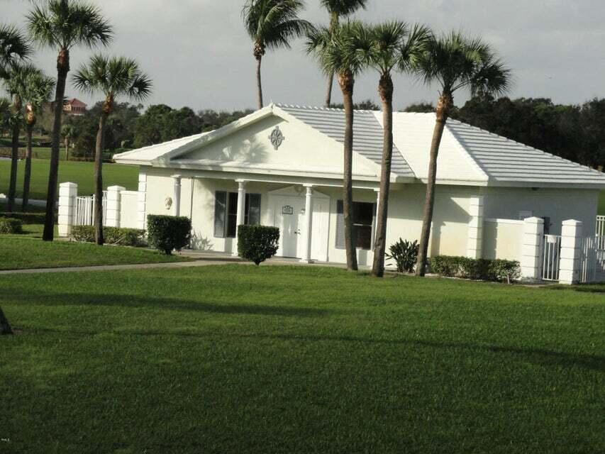 2441 Village Boulevard, Unit 405 West Palm Beach, FL 33409 - Photo 24 of 24 a front view of a house with a garden