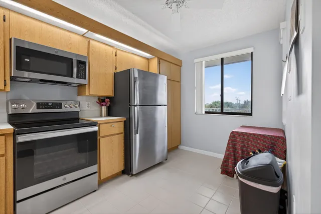 a kitchen with stainless steel appliances granite countertop a refrigerator stove and microwave