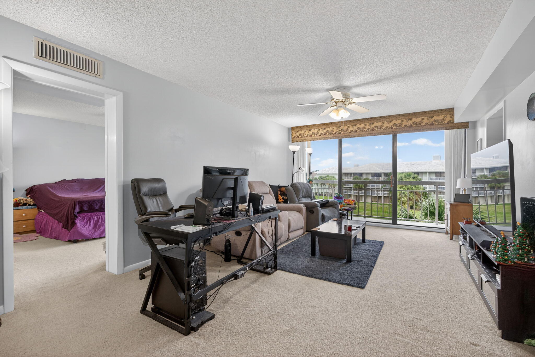 2441 Village Boulevard, Unit 405 West Palm Beach, FL 33409 - Photo 10 of 24 a workspace with a large window and sitting area