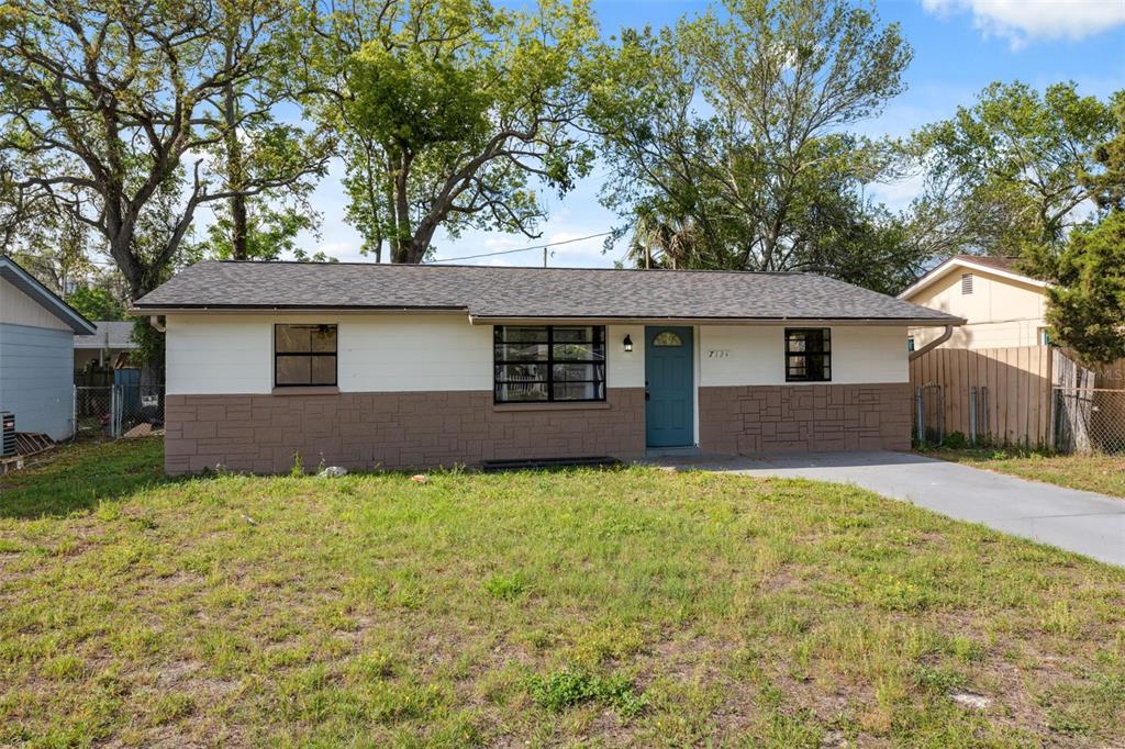a house that has a tree in front of it