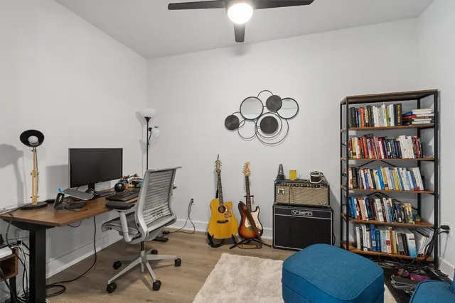 a view of a workspace with furniture and a bookshelf