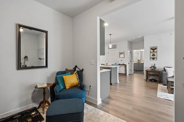 a hallway with furniture and wooden floor