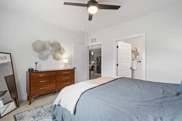 a bedroom with a bed and a dresser