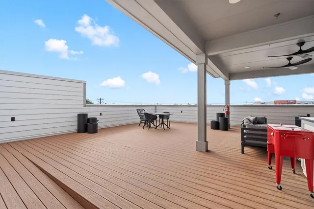 a view of a patio with dining table and chairs with wooden floor