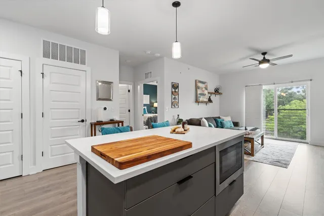 a room with a bed a window and a chandelier