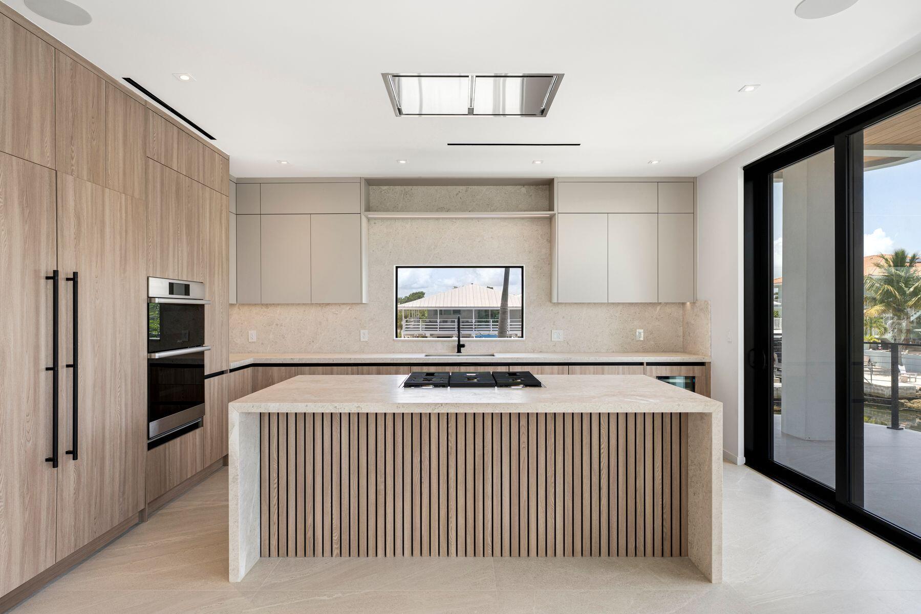301 Buttonwood Circle, Unit B Key Largo, FL 33037 - Photo 13 of 40 a kitchen with stainless steel appliances granite countertop a sink and a refrigerator