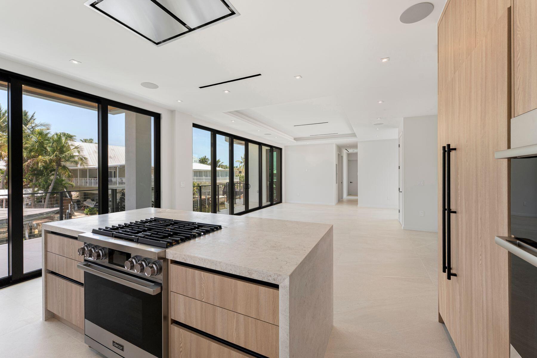301 Buttonwood Circle, Unit B Key Largo, FL 33037 - Photo 15 of 40 a kitchen that has a stove and a refrigerator
