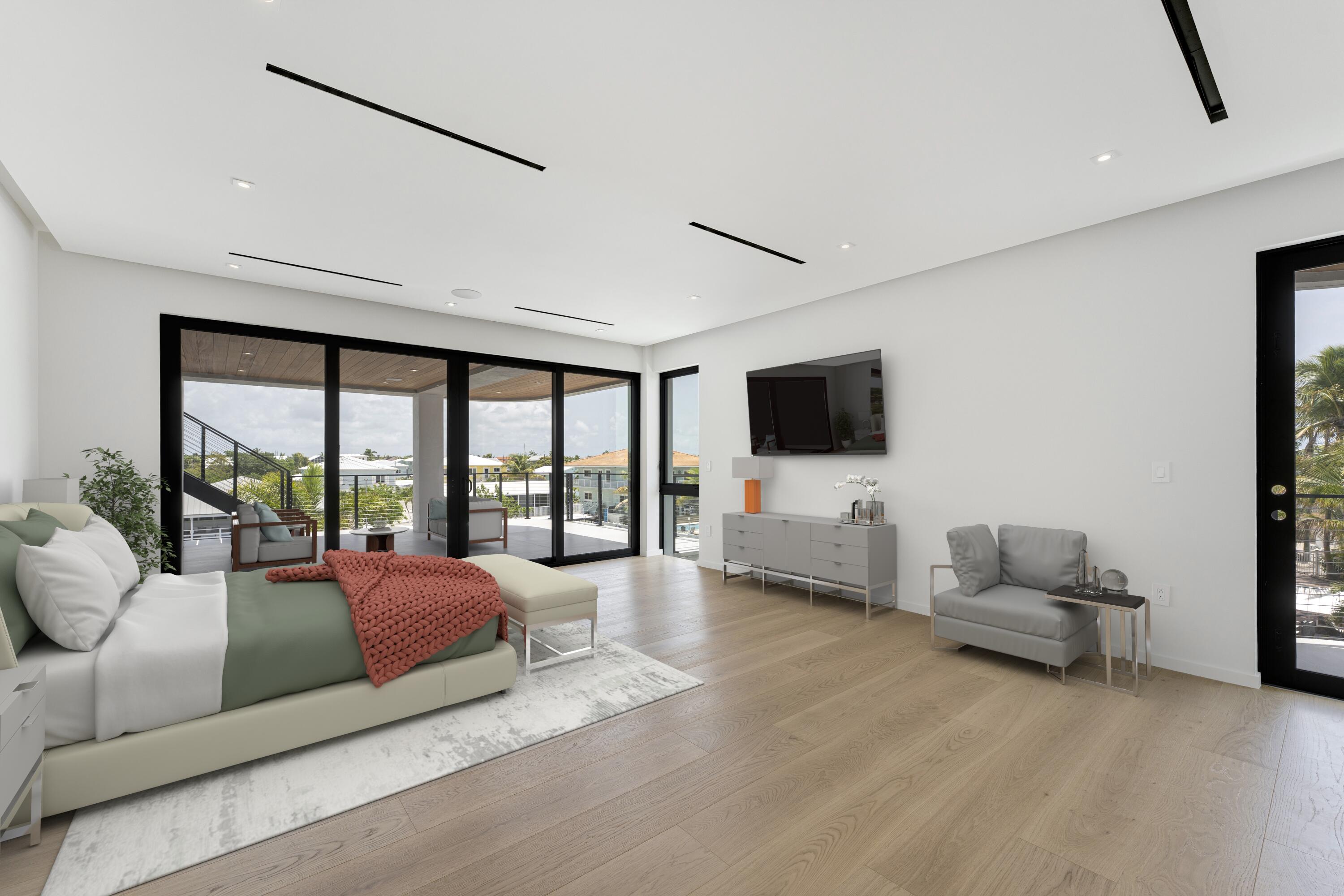 301 Buttonwood Circle, Unit B Key Largo, FL 33037 - Photo 16 of 40 a bedroom with furniture and a flat screen tv