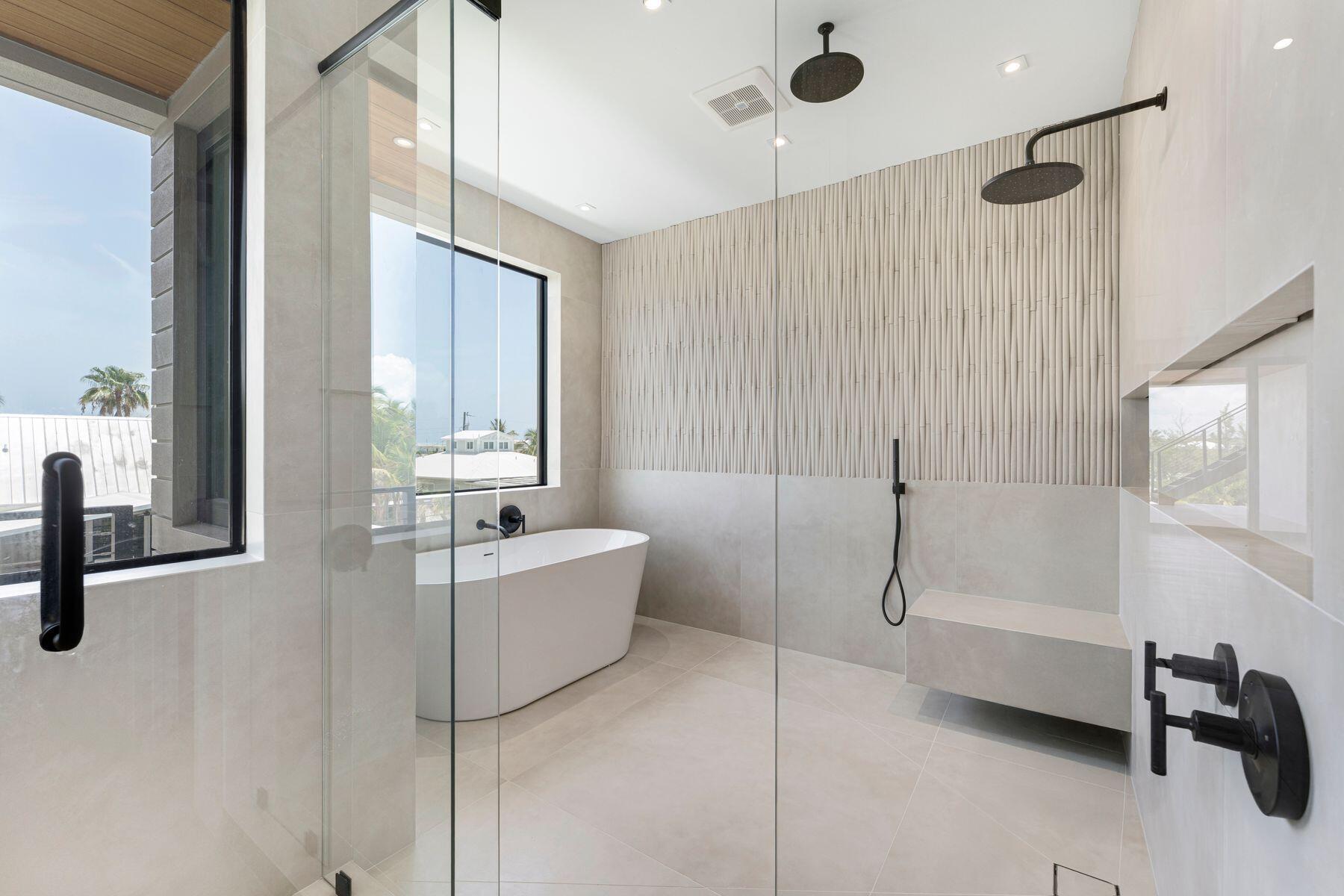 301 Buttonwood Circle, Unit B Key Largo, FL 33037 - Photo 22 of 40 a bathroom with a tub and a shower