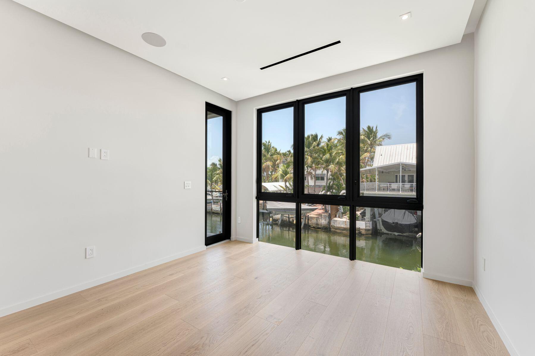 301 Buttonwood Circle, Unit B Key Largo, FL 33037 - Photo 27 of 40 wooden floor in an empty room with a window